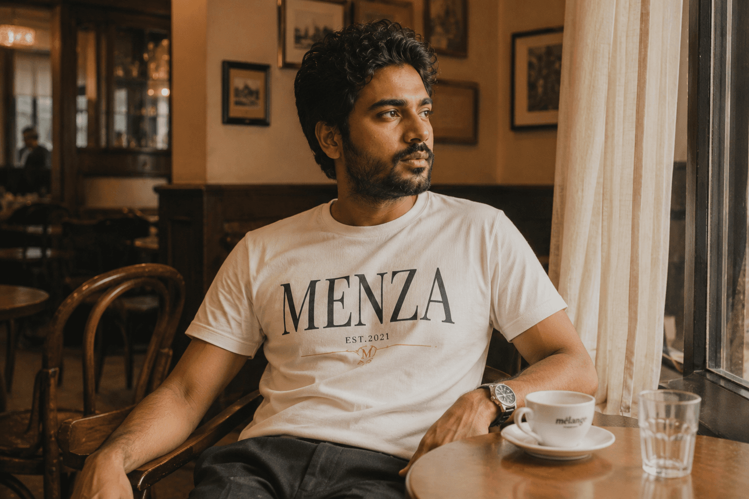 Indian man wearing MENZA graphic printed tee with pastel-colored artwork design, Mumbai street style